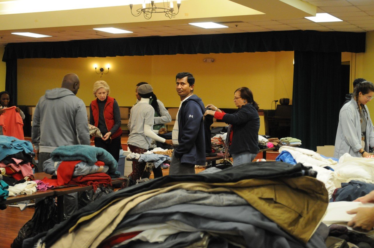 Community members gathered during a clothing outreach event