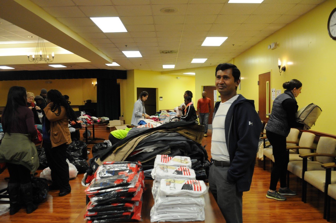 Volunteers with clothing and essential items at an outreach program