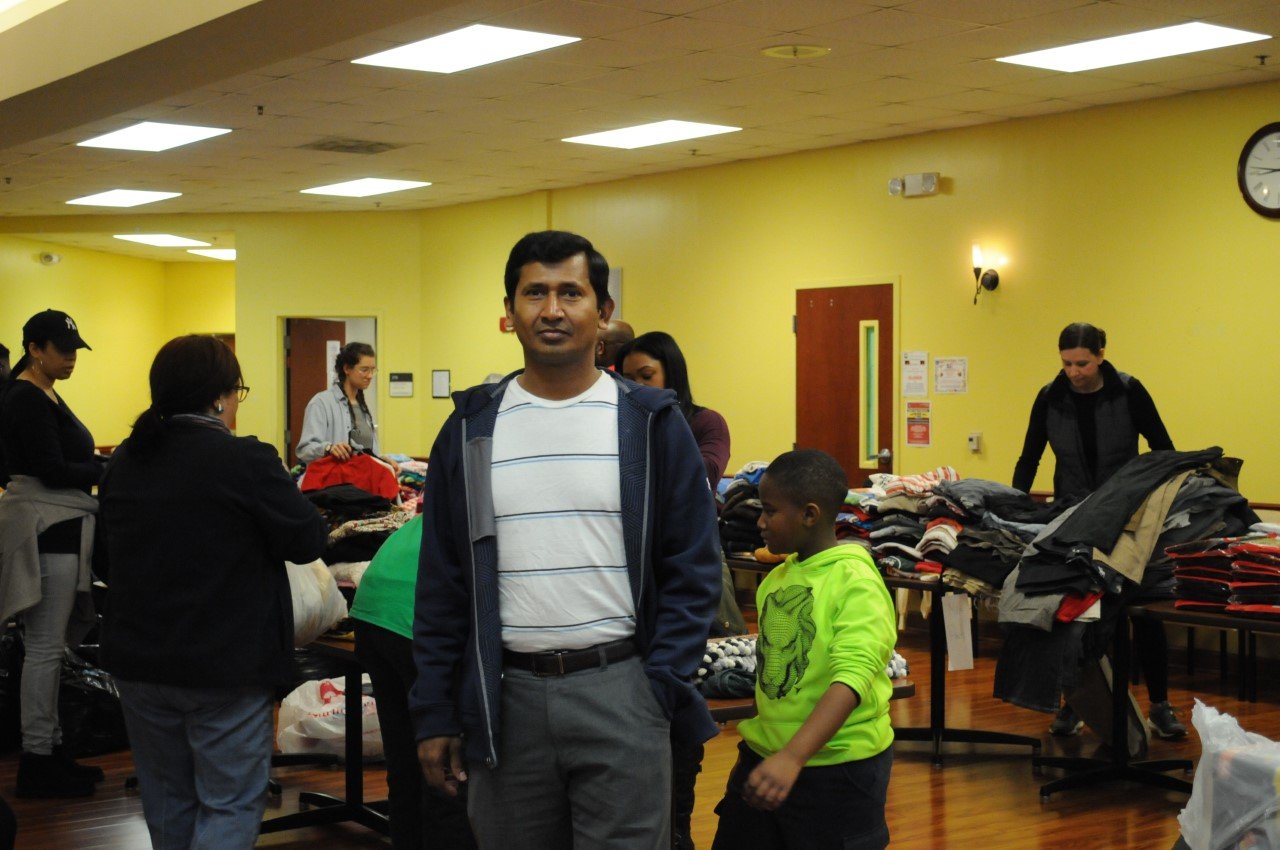Volunteers working together around clothing donations.